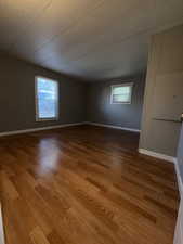 Spare room featuring light wood-style floors and baseboards