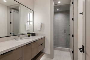 Full bath featuring a shower stall, vanity, light tile patterned flooring, and recessed lighting