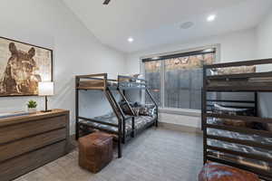 Bedroom with a ceiling fan, recessed lighting, lofted ceiling, and light carpet