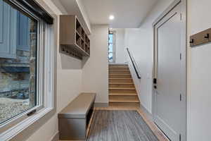 Mudroom featuring baseboards and light wood-style floors