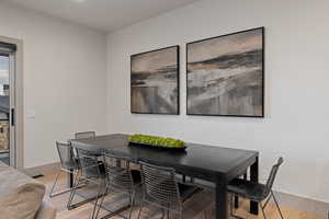 Dining area with light wood-style floors and baseboards