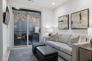 Living area with wood finished floors and baseboards