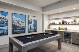 Game room with wine cooler, light colored carpet, recessed lighting, billiards table, and bar