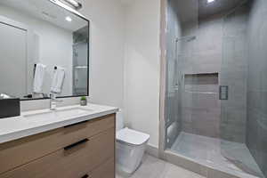 Bathroom featuring vanity and a shower stall