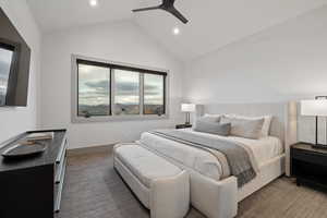 Bedroom featuring vaulted ceiling, carpet flooring, and a ceiling fan