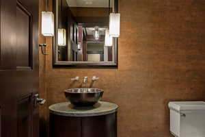 Half bathroom with vanity and toilet