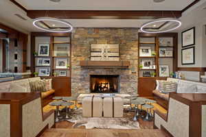 Living area with a fireplace, wood finished floors, and built in features