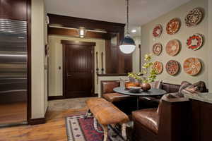 Dining room with light wood-style flooring and recessed lighting