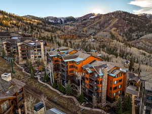 Aerial view of a mountain backdrop and apartment complex / building
