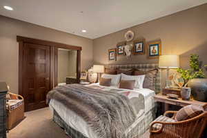 Carpeted bedroom with recessed lighting