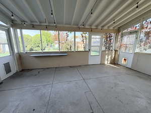 Unfurnished sunroom featuring healthy amount of natural light