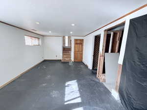 Empty room featuring crown molding, recessed lighting, a textured ceiling, and concrete flooring