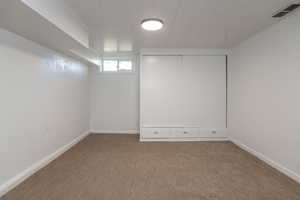 Basement featuring carpet floors and baseboards