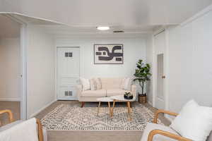 Living area featuring carpet flooring and baseboards