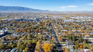Aerial overview of property's location featuring a mountainous background and nearby suburban area