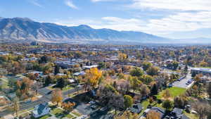 Aerial overview of property's location featuring a mountain backdrop and nearby suburban area