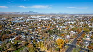 Aerial view of property's location with nearby suburban area and mountains