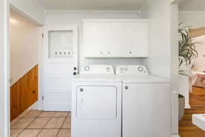 Washroom featuring crown molding and separate washer and dryer