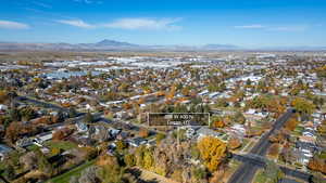 Aerial view of property's location featuring nearby suburban area and a mountainous background