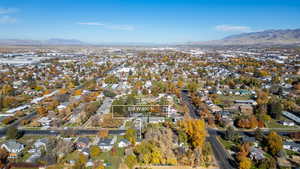 Aerial overview of property's location featuring nearby suburban area and a mountain backdrop