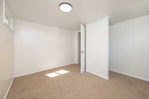 Unfurnished bedroom featuring carpet flooring and baseboards