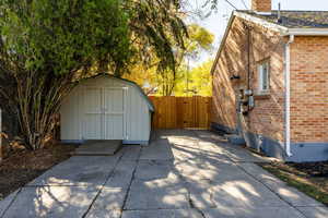 View of patio with a shed