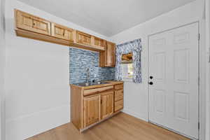 Kitchen featuring decorative backsplash and light wood-style floors