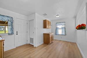 Foyer with light wood-type flooring and a textured ceiling