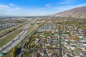 Aerial overview of property's location with a mountain backdrop and nearby suburban area
