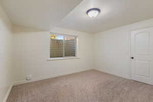 Empty room with baseboards and carpet