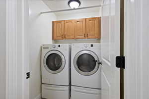Laundry room featuring cabinet space and independent washer and dryer