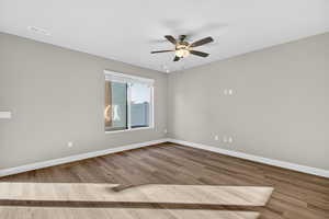 Empty room featuring light wood-style floors and a ceiling fan