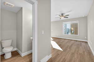 Half bathroom featuring light wood-style flooring and ceiling fan