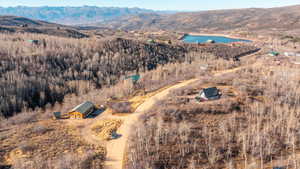 Aerial overview of property's location featuring a water and mountain view