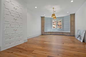 Unfurnished dining area with light wood-type flooring and recessed lighting