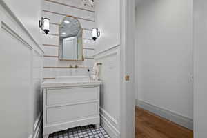Bathroom with vanity and dark wood-style flooring
