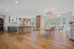 Kitchen with arched walkways, pendant lighting, plenty of natural light, recessed lighting, and wood ceiling