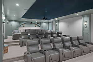 Home theater with recessed lighting, carpet, and a tray ceiling