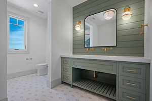 Bathroom featuring vanity, recessed lighting, and wooden walls