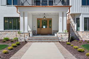 Entrance to property with stone siding and covered porch