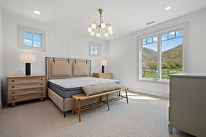 Bedroom with multiple windows, carpet, a chandelier, a mountain view, and recessed lighting