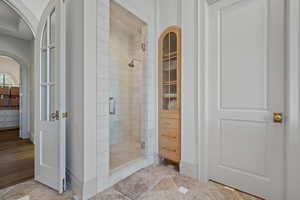Full bathroom with a stall shower and light tile patterned floors