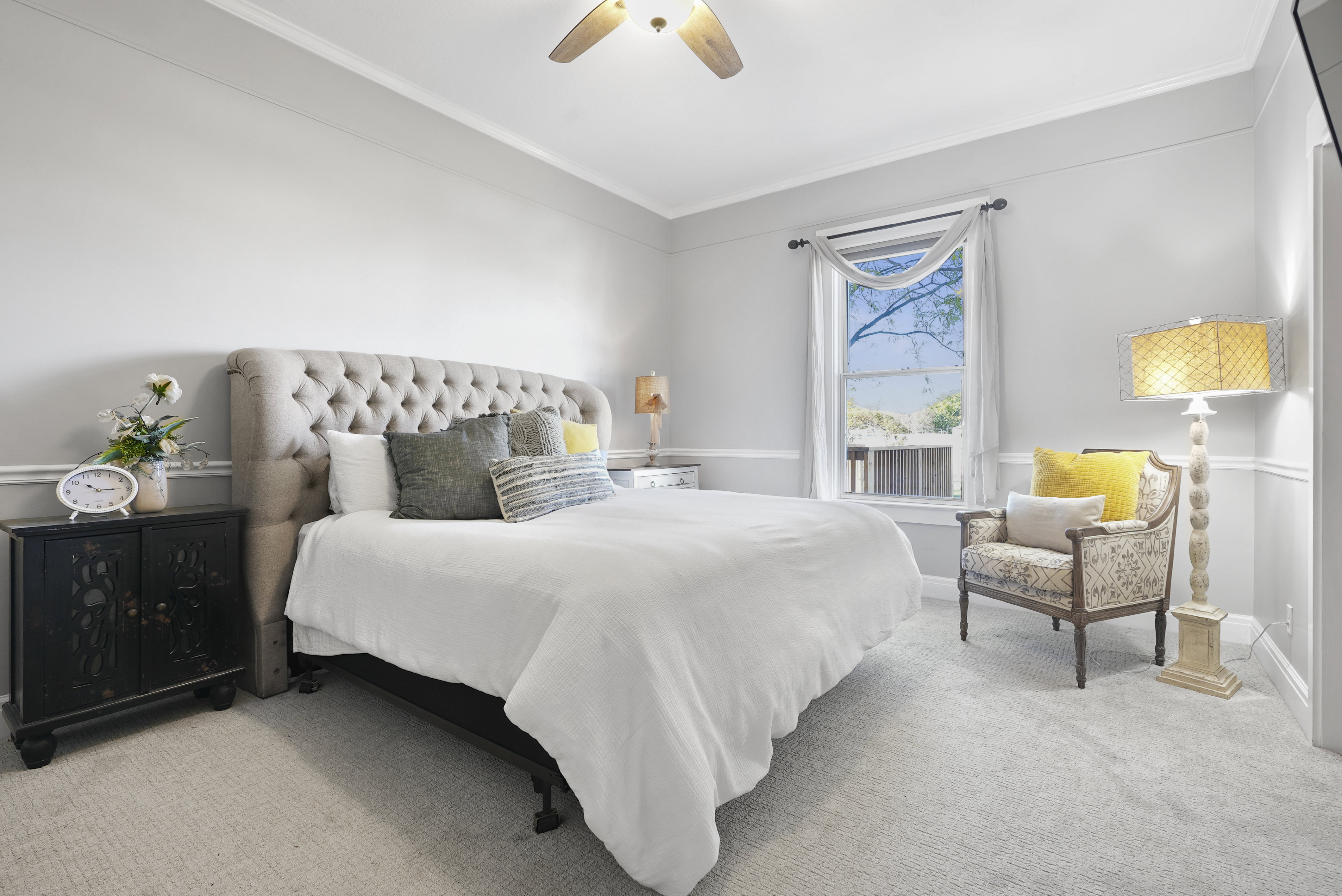 Carpeted bedroom featuring ornamental molding and ceiling fan