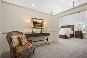 Primary Suite sitting area featuring crown molding, carpet floors, vaulted ceiling, and recessed lighting