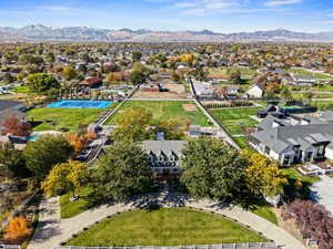 Aerial perspective of the home with a mountainous background featuring 1.47 acres and circular driveway