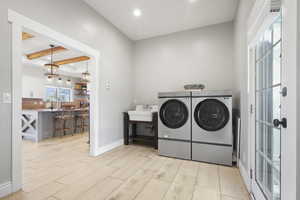 Laundry/Mud Room area featuring light floors, beamed ceiling, separate washer and dryer, and recessed lighting