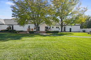 Back yard view of property featuring board and batten siding