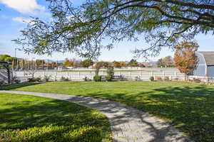 View of backyard including horse pasture, outbuilding and pergola
