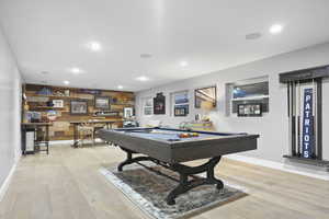 Game room pool table, recessed lighting, wet bar and wooden accent wall