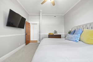 Bedroom featuring crown molding, carpet flooring, and ceiling fan